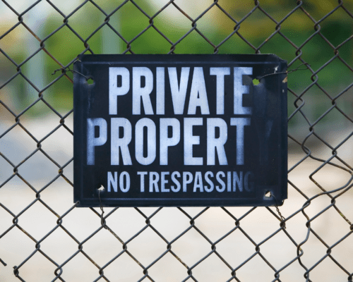 A sign on a fence that reads 