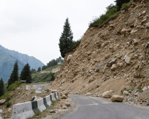 A sloped dirt hill by a road. Landslide angle.