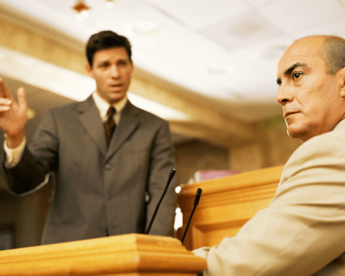 A lawyer questioning a witness in a court of law.