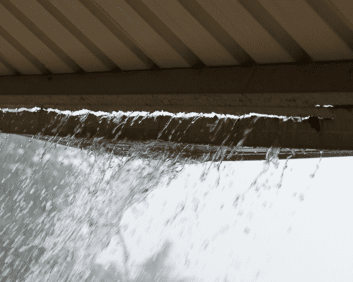 Rain water pouring off a roof.