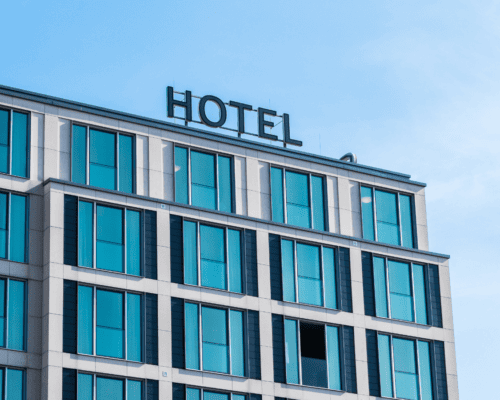 A modern multi-story hotel building with large windows and signage, representing a hospitality property whose value in an eminent domain case depends on factors like revenue, occupancy, and business goodwill in Los Angeles.