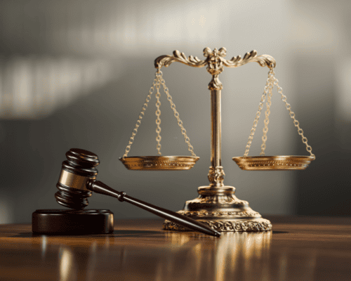 Judge’s gavel and scales of justice on a table, symbolizing the legal complexities of valuing infrastructure properties in California eminent domain cases involving easements, partial takings, and specialized assets.