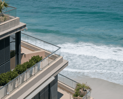 Luxury waterfront property with private balconies overlooking the ocean, representing the unique value of marina and waterfront real estate in California eminent domain cases.